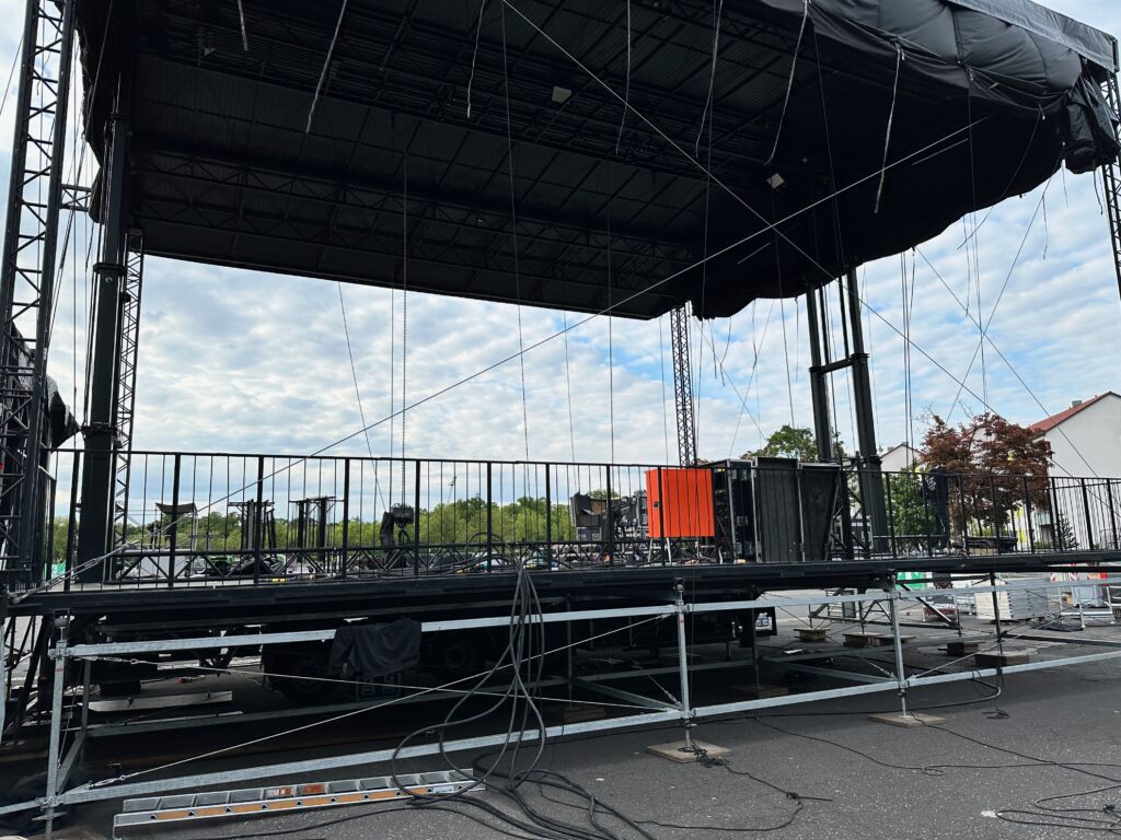Aufgebaute Open-Air-Bühne mit Dach vor dem Veranstaltungsbeginn